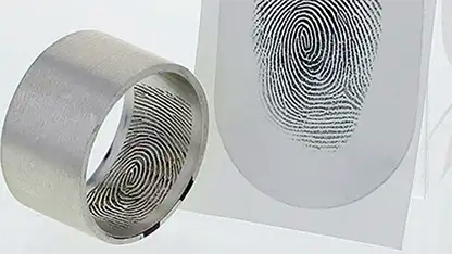 Close-up of a fingerprint laser-engraved on the inside of a titanium ring